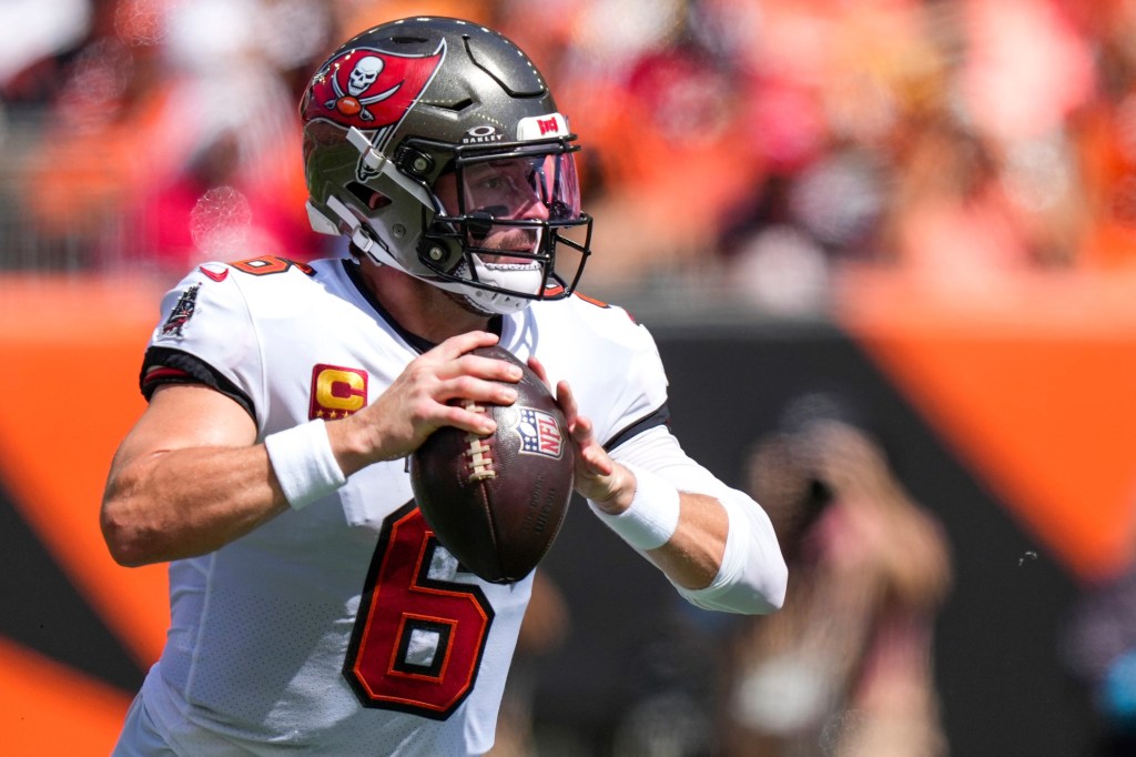 Tampa Bay Buccaneers quarterback Baker Mayfield in his uniform dropping back to throw a football.