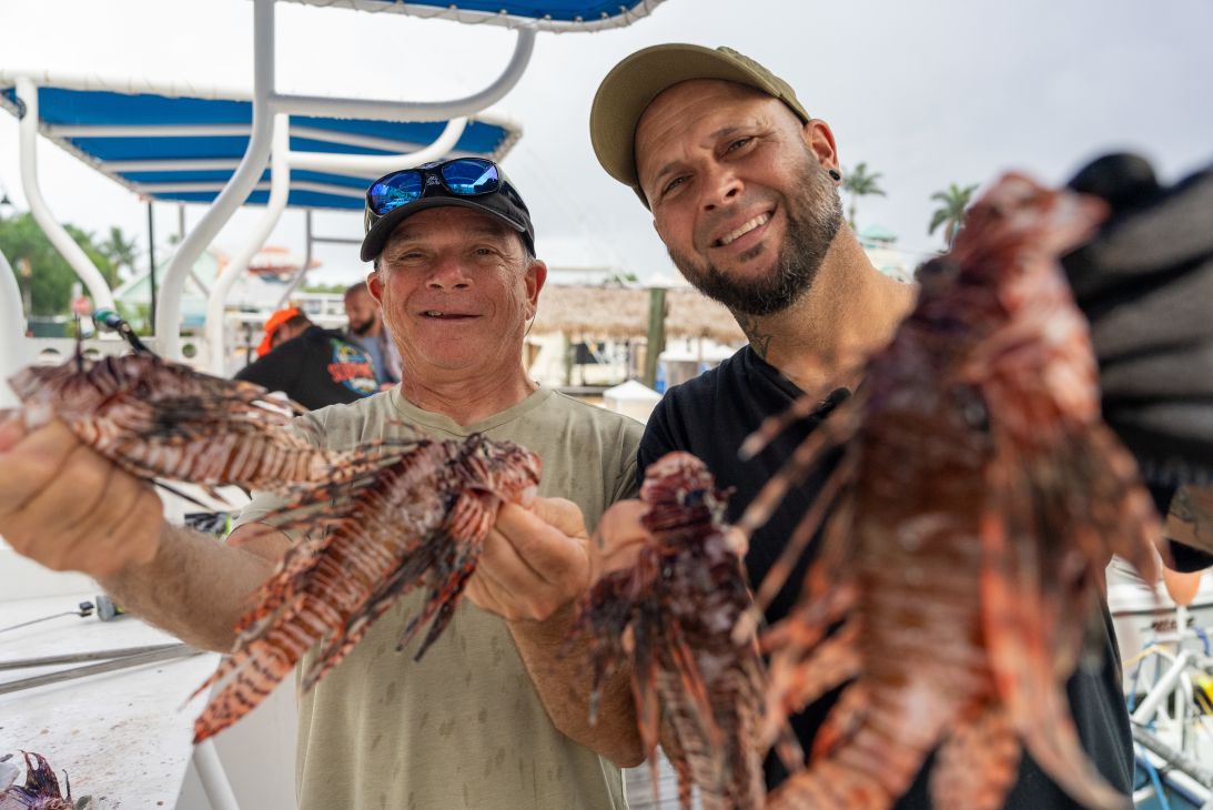 Alex Borsutzky and Nate Sorensen pose together with their catch. The largest lionfish Sorensen has caught was close to 18 inches long.