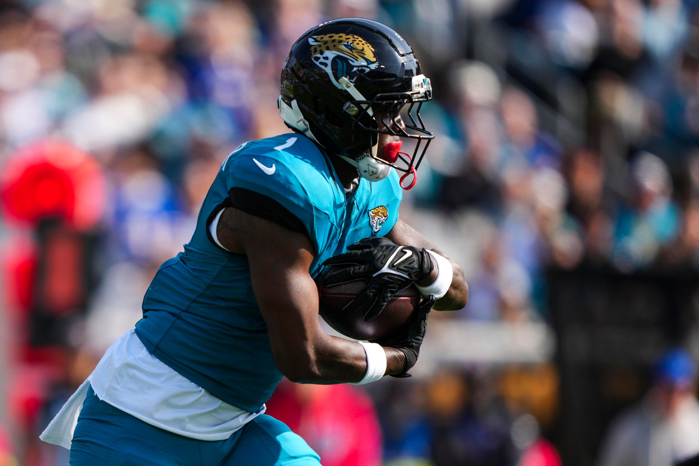 JACKSONVILLE, FLORIDA - JANUARY 11: Travis Etienne Jr. #1 of the Jacksonville Jaguars runs the ball during an NFL wild card playoff football game against the Buffalo Bills at EverBank Stadium on January 11, 2026 in Jacksonville, FL. (Photo by Perry Knotts/Getty Images)