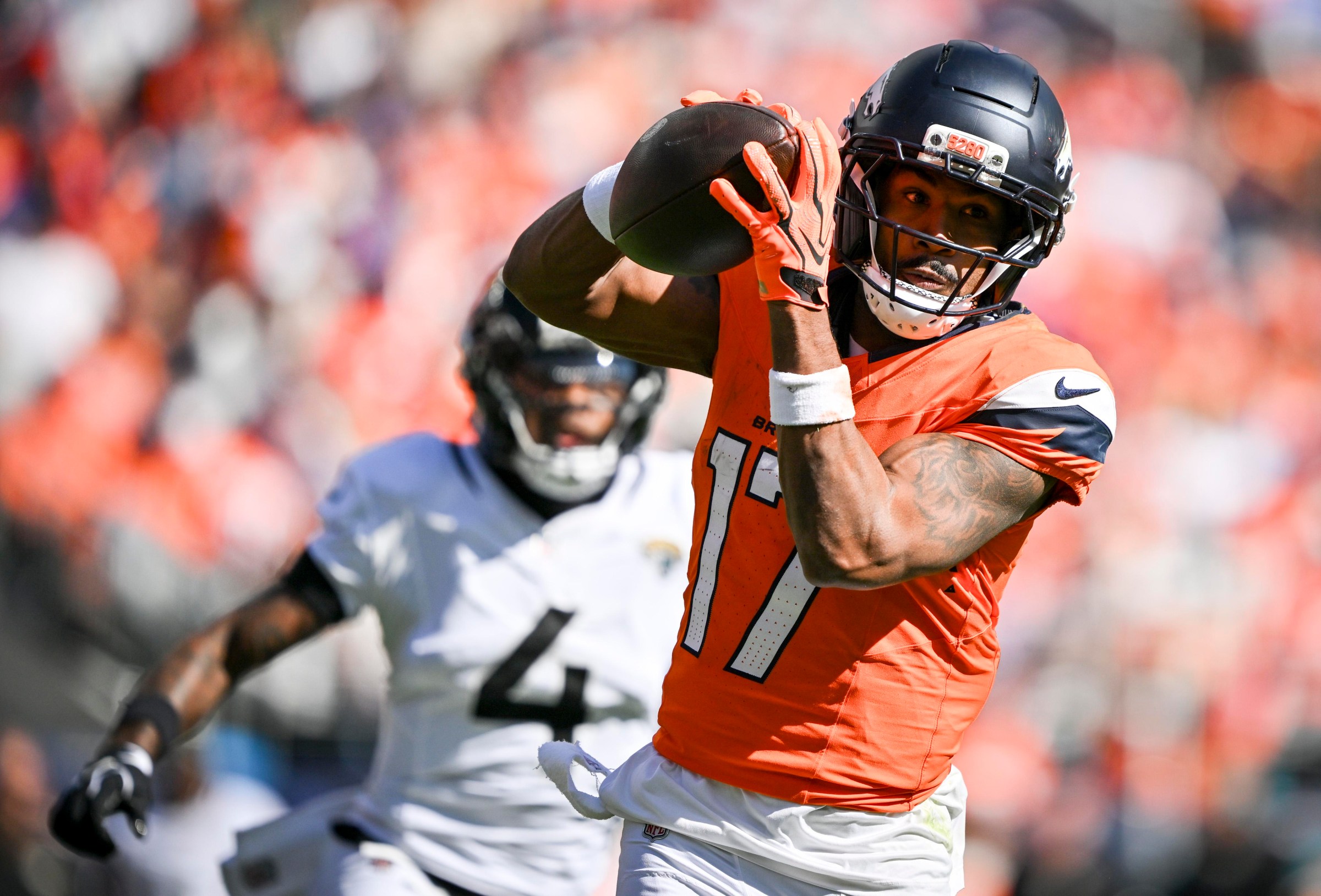 DENVER , CO - SEPTEMBER 20: Jaylen Waddle (17) of the Denver Broncos hauls in a pass as Jarrian Jones (4) of the Jacksonville Jaguars chases during the second quarter at Empower Field at Mile High in Denver, Colorado on Sunday, September 20, 2026. (Photo by AAron Ontiveroz/The Denver Post)