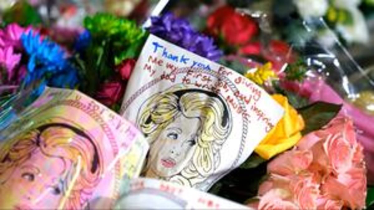 Visitors don dresses for Dolly Parton Day at Jacksonville Flower Market on Friday