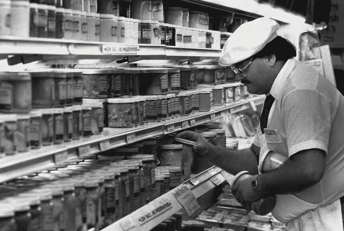 Harvey Donowitz stocks the kosher cooked food shelves at the Epicure Market.
