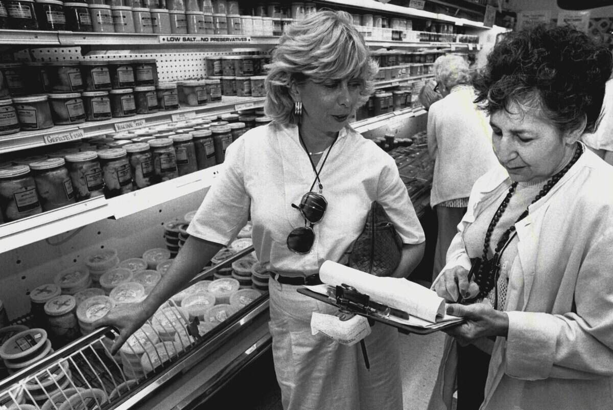 Phyllis Forstein places her Passover Seder dinner order with Cecile Fernandez at Epicure Market.