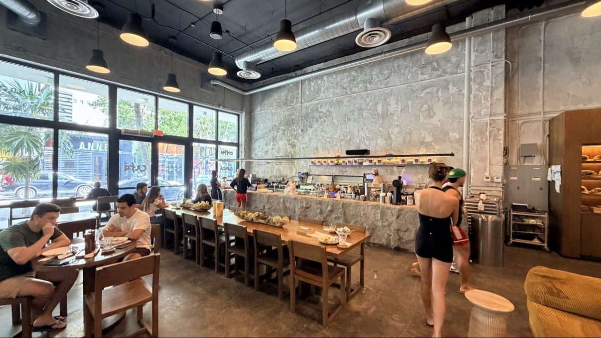 Guests drinking coffee inside a Miami coffee shop on National Coffee Day