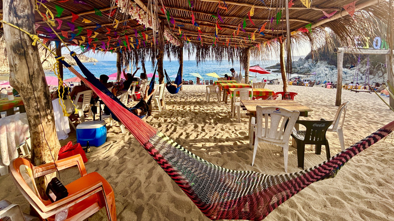 A hammock hanging in a beach bar at Tejon Beach in Huatulco, Mexico