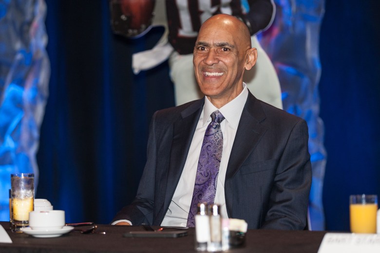 Former NFL head coach Tony Dungy speaking at a table during the AIA 2017 Bart Starr Award Super Bowl Breakfast in Houston, Texas.
