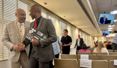 Michael Smith, principal of Baldwin Middle-Senior High School, left, shakes a colleague's hand.