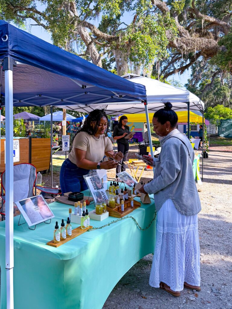 a vendor and shopper at Tampa Plant Market