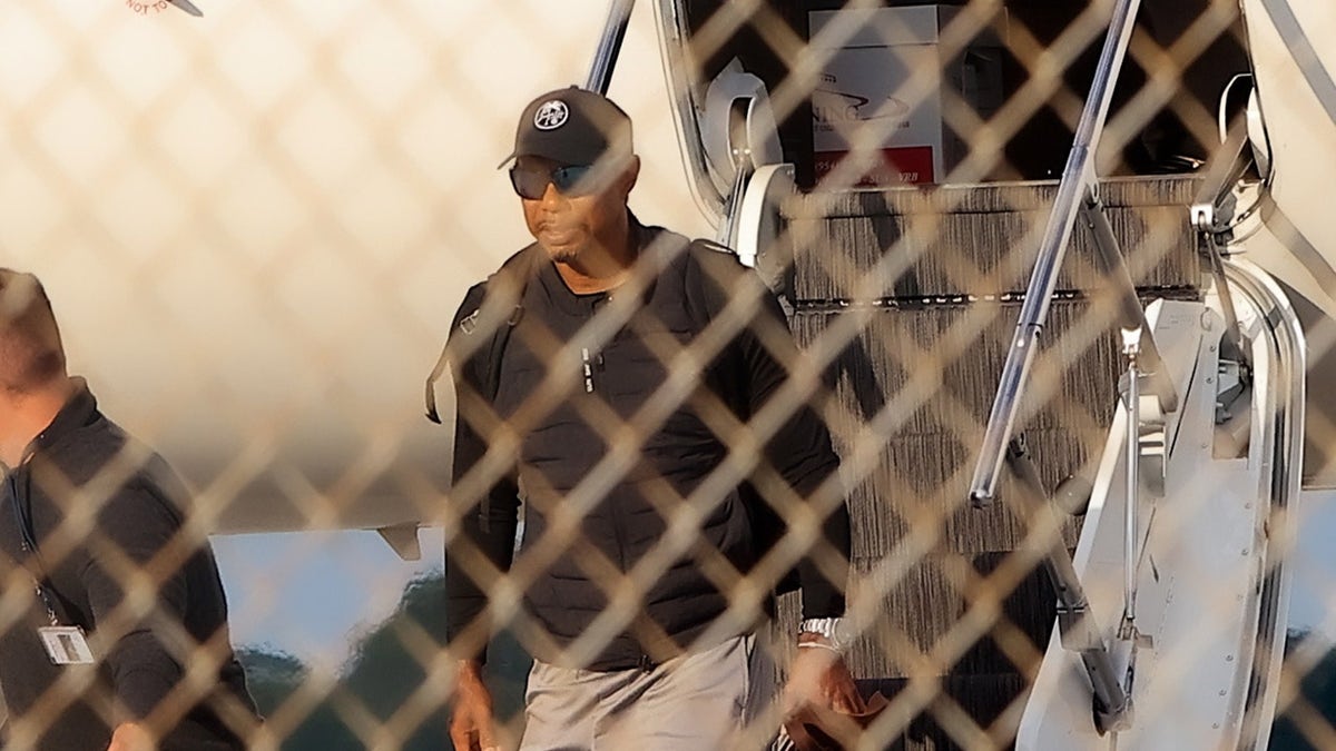 Tiger Woods getting off plane