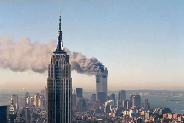 The twin towers of the World Trade Center burn behind the Empire State Building in New York on Sept. 11, 2001. (Marty Lederhandler/AP file)