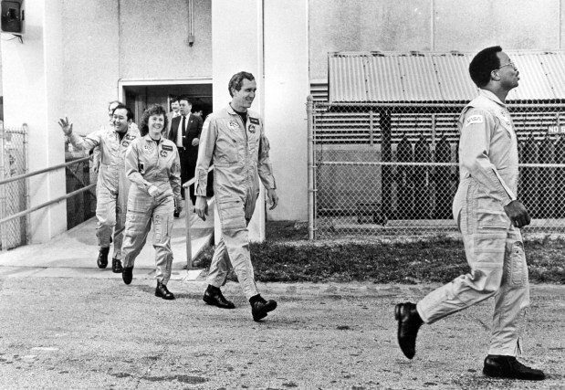 Crew members from what would be the final Space Shuttle Challenger launch walk out on January 28, 1986. Pictured are (left to right) Ellison Onizuka, Christa McAuliffe, Michael Smith and Ronald McNair. (Red Huber/Orlando Sentinel file)