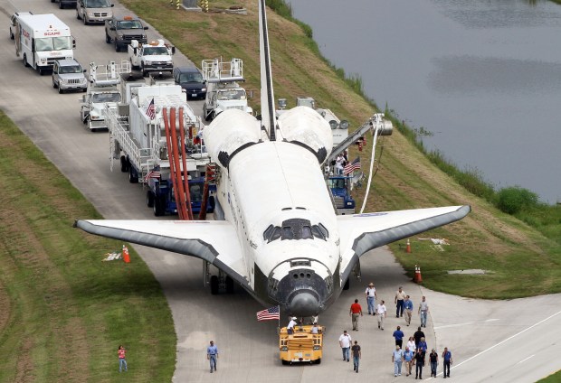 Space Shuttle Atlantis gets towed after landing at Kennedy Space Center on July 21, 2011. It marked the final flight of NASA's Space Shuttle Program that spanned 30 years and 135 missions. (Red Huber/Orlando Sentinel file)