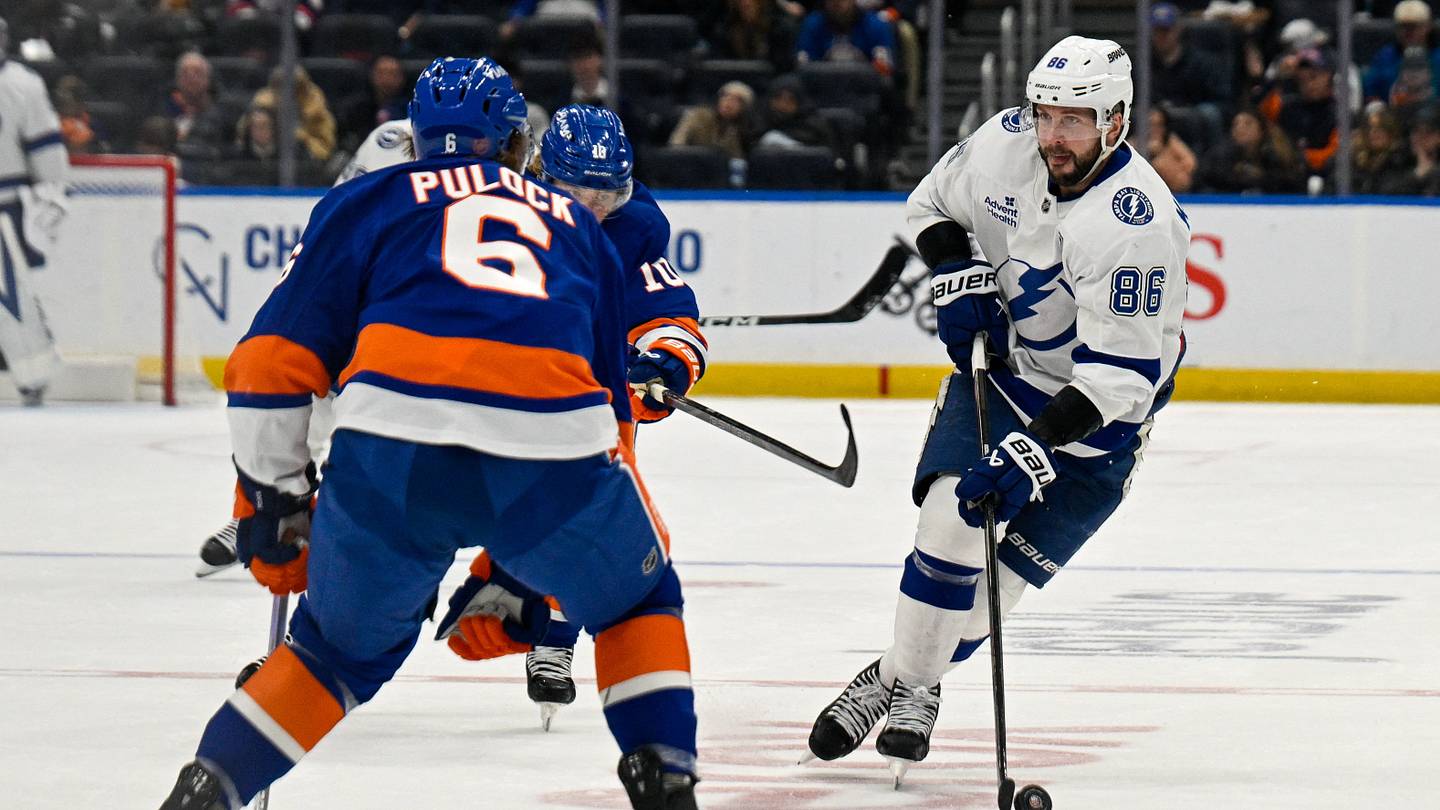 Dec 13, 2025; Elmont, New York, USA; Tampa Bay Lightning right wing Nikita Kucherov (86) skated into the zone defended by New York Islanders defenseman Ryan Pulock (6) during during the third period at UBS Arena. Mandatory Credit: Dennis Schneidler-Imagn Images