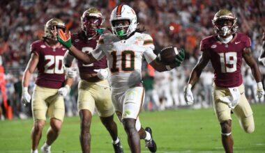 Oct 4, 2025; Tallahassee, Florida, USA; Miami Hurricanes wide receiver Malachi Toney (10) scores a touchdown against Florida State Seminoles defensive back Earl Little Jr. and defensive back Jerry Wilson (19) during the second half at Doak S. Campbell Stadium. Mandatory Credit: Robert Myers-Imagn Images