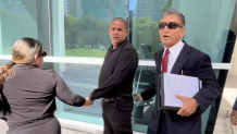 Yusiel Lopez Insua (center) outside court on July 21, 2026.
