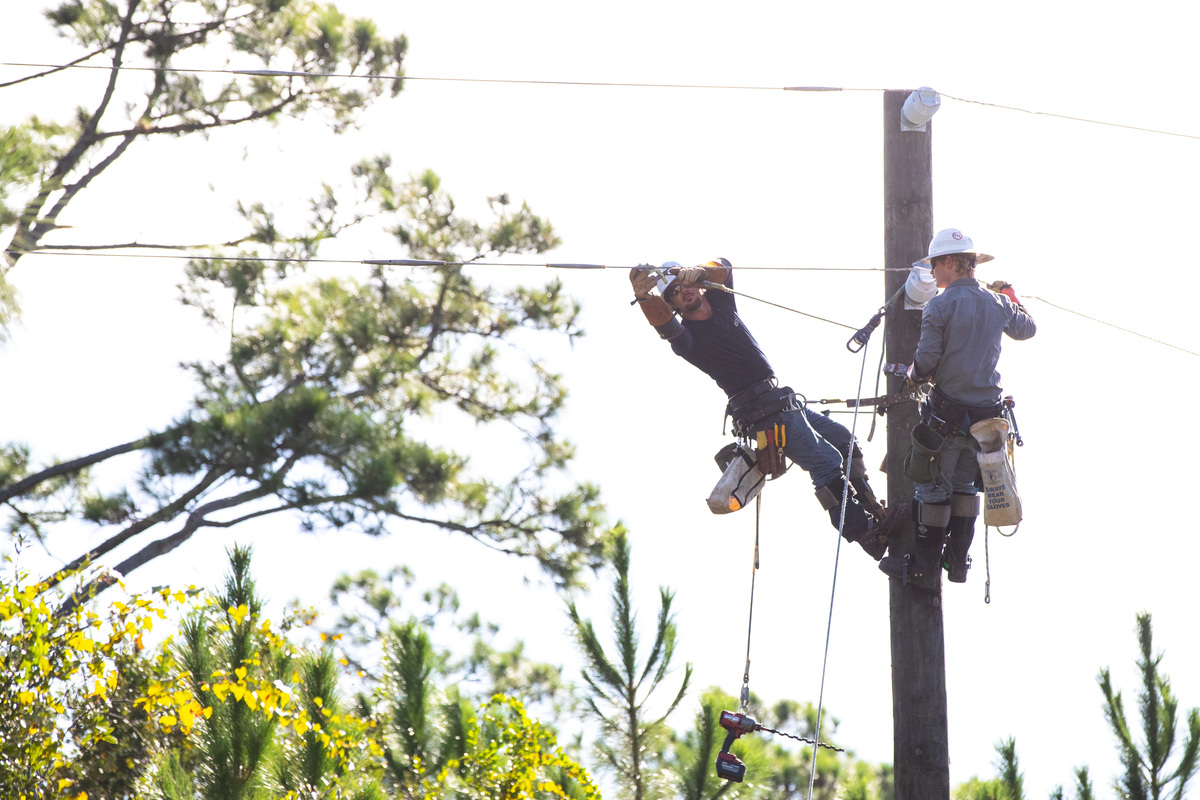 Duke Energy linemen repair fallen power lines in Eastpoint, Florida, down the street from the Franklin County Florida Sheriff's Office, Saturday, Oct. 10, 2026, after Hurricane Isaias made landfall on the Gulf Coast.