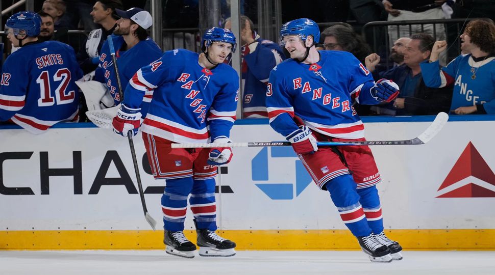 New York Rangers' Alexis Lafrenière, right, celebrates his second goal of the night during the first period of an NHL hockey game against the Tampa Bay Lightning in New York, Tuesday, Oct. 13, 2026. (AP Photo/Seth Wenig)