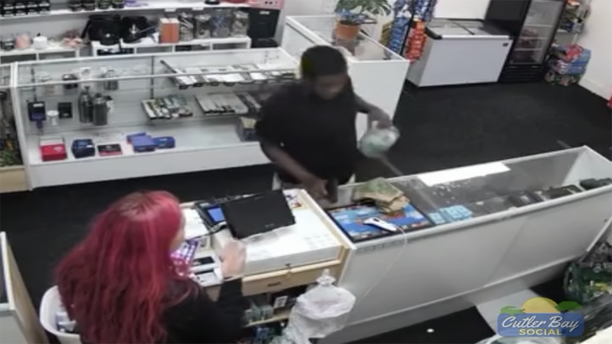 Video showed an armed suspect taking a tip jar from a smoke shop.