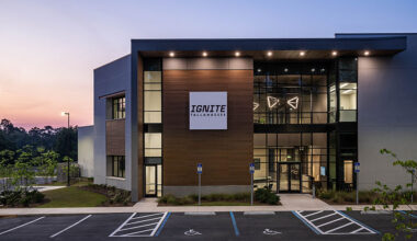 A view at the front of a building with a sign reading "IGNITE Tallahassee" during sunset.