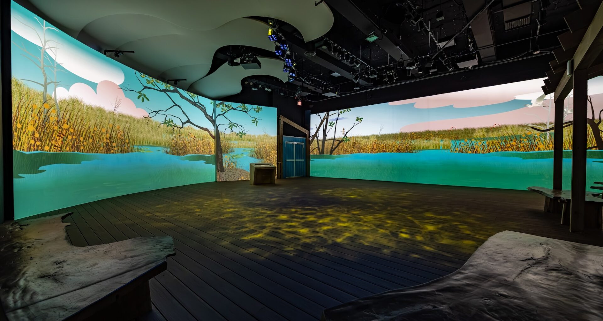 photo of a room inside a museum with two wall-sized LED screens depicting the Everglades