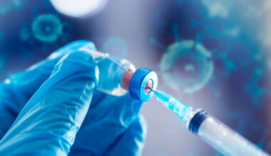 Covid-19 vaccination with vaccine bottle and syringe injection tool for coronavirus immunization treatment.