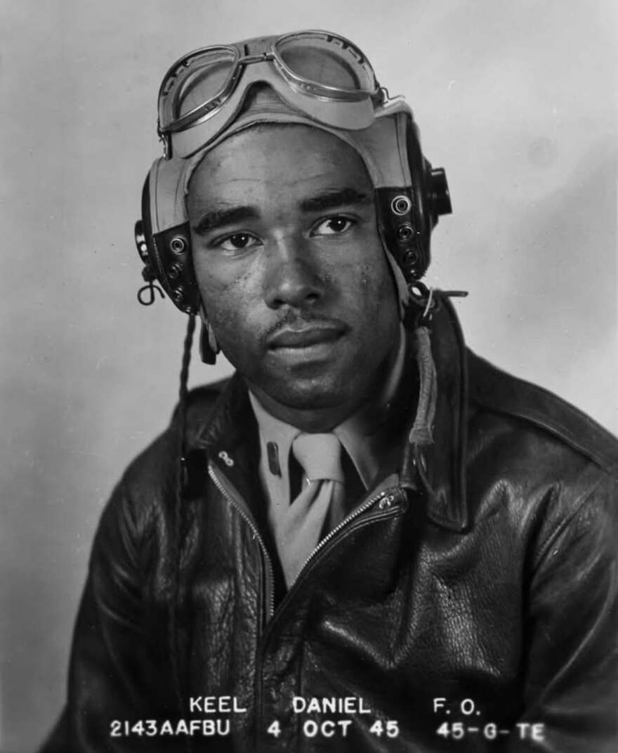 A black-and-white graduation photo of a Black military pilot.
