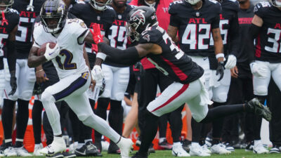 Aug 17, 2024; Baltimore, Maryland, USA; Baltimore Ravens wide receiver Malik Cunningham (12) gains yards after a second quarter catch defended by Atlanta Falcons safety Tre Tarpley III (38) at M&T Bank Stadium.