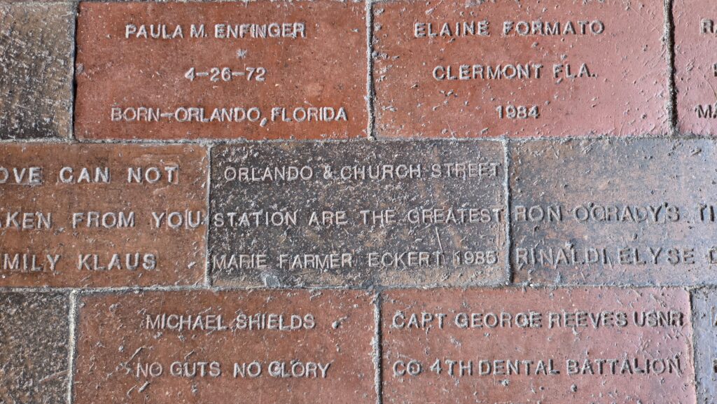 Several engraved bricks that are part of a sidewalk.