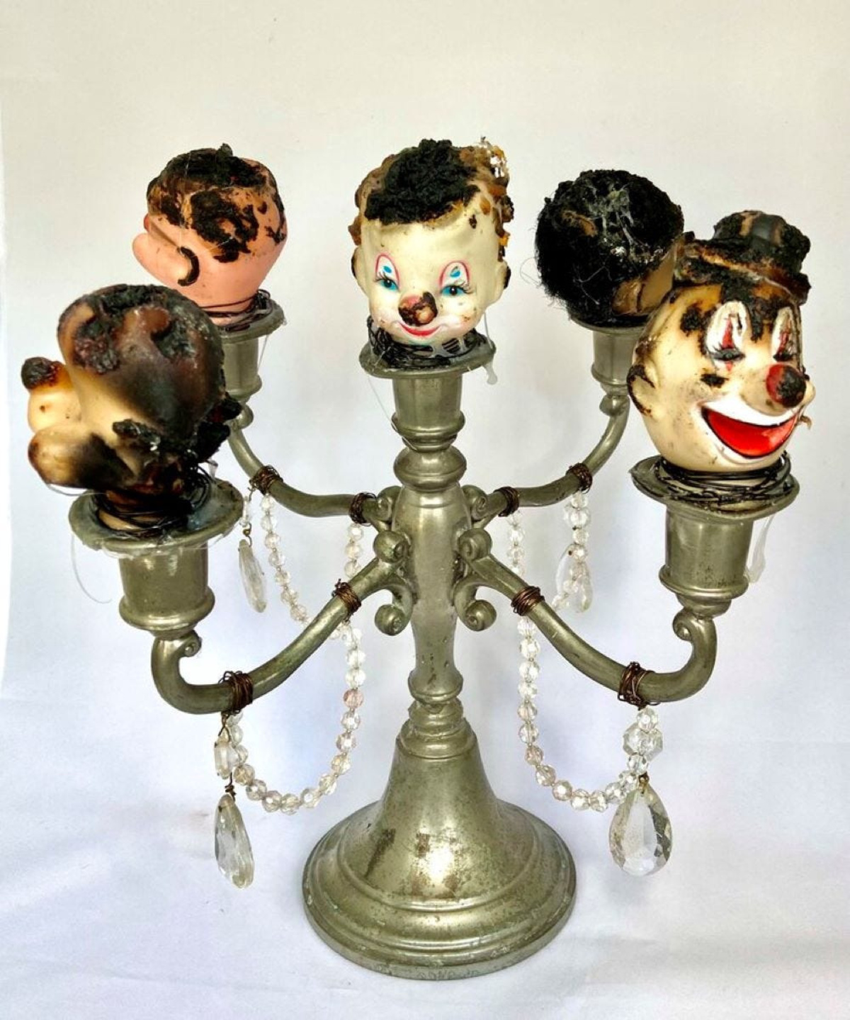 Artist Pamela Jones' award-winning assemblages use repurposed objects, including the vintage rubber clown heads in her creepy “Bad Clowns” series.