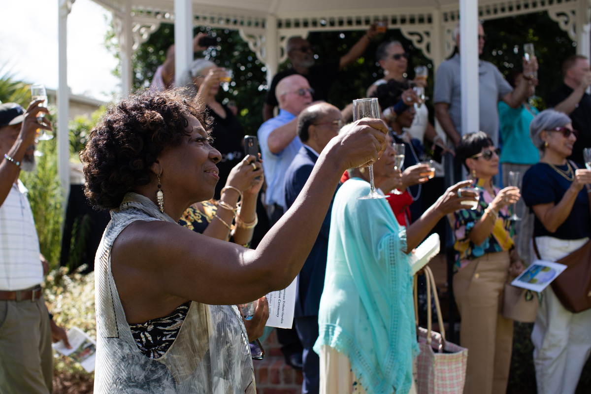 Attendees hold up their glasses for a toast during the Oct. 1 LeMoyne Arts African American Tribute Garden Dedication Ceremony.