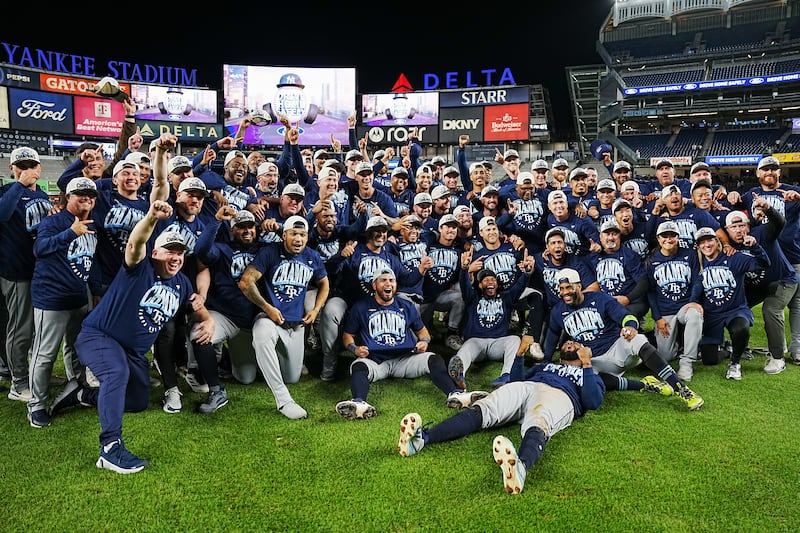 NEW YORK, NY - SEPTEMBER 22: Members of the Tampa Bay Rays pose for a group photo on the field after defeating the New York Yankees to clinch the American League East title at Yankee Stadium on Tuesday, September 22, 2026 in New York, New York. (Photo by Mary DeCicco/MLB Photos via Getty Images)