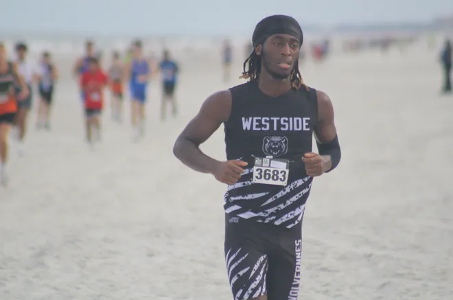 Westside's De'shaun Henry (3683) runs in the boys race during the Nor'Eastern Classic high school cross country meet on Sept. 29, 2026 in Jacksonville Beach, Florida. [Clayton Freeman/Florida Times-Union]