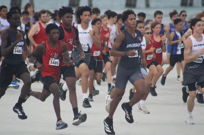 Runners break from the boys starting line during the Nor'Eastern Classic high school cross country meet on Sept. 29, 2026 in Jacksonville Beach, Florida. [Clayton Freeman/Florida Times-Union]