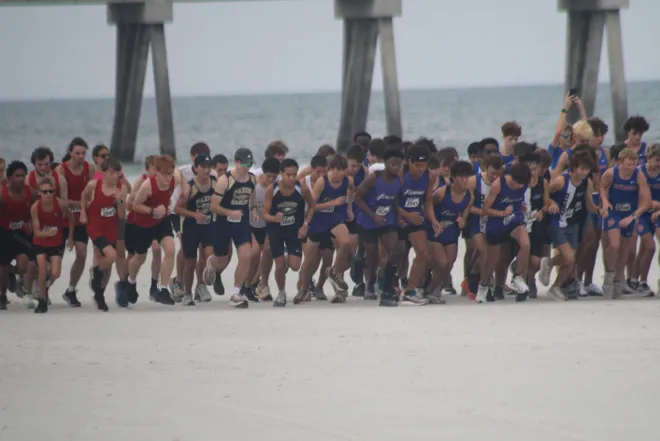 Runners break from the boys starting line during the Nor'Eastern Classic high school cross country meet on Sept. 29, 2026 in Jacksonville Beach, Florida. [Clayton Freeman/Florida Times-Union]