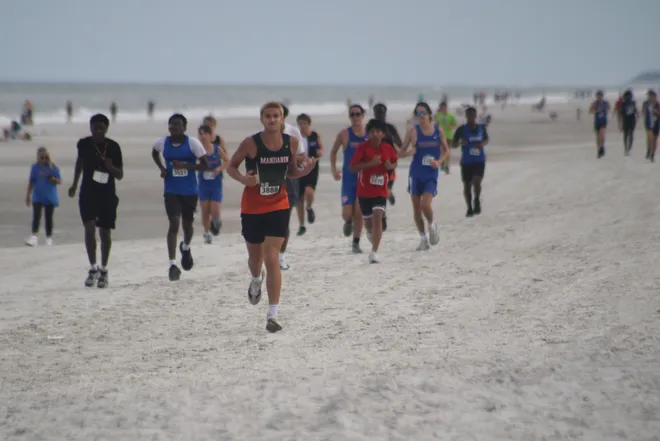 Runners make their way along the course in the boys race during the Nor'Eastern Classic high school cross country meet on Sept. 29, 2026 in Jacksonville Beach, Florida. [Clayton Freeman/Florida Times-Union]