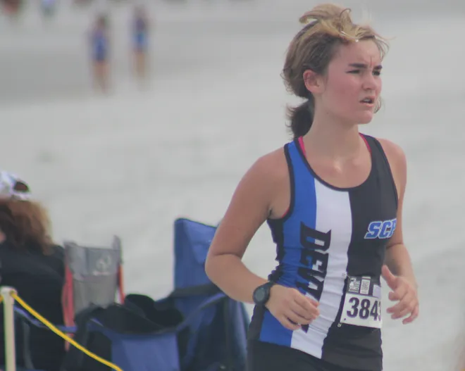 Stanton's Olive Arnold (3843) runs in the girls race during the Nor'Eastern Classic high school cross country meet on Sept. 29, 2026 in Jacksonville Beach, Florida. [Clayton Freeman/Florida Times-Union]