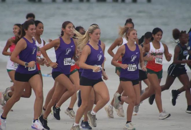 Runners break from the girls start line during the Nor'Eastern Classic high school cross country meet on Sept. 29, 2026 in Jacksonville Beach, Florida. [Clayton Freeman/Florida Times-Union]