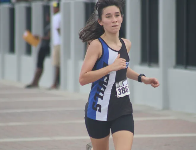 Stanton's Audrey Parman (3861) runs to the girls finish line in third during the Nor'Eastern Classic high school cross country meet on Sept. 29, 2026 in Jacksonville Beach, Florida. [Clayton Freeman/Florida Times-Union]