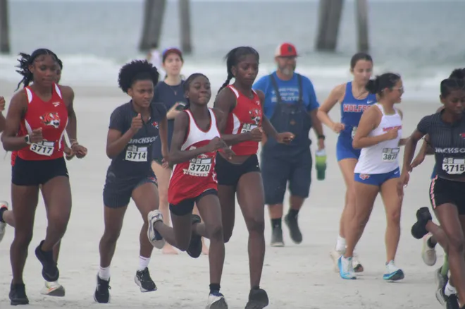 Runners break from the girls start line during the Nor'Eastern Classic high school cross country meet on Sept. 29, 2026 in Jacksonville Beach, Florida. [Clayton Freeman/Florida Times-Union]