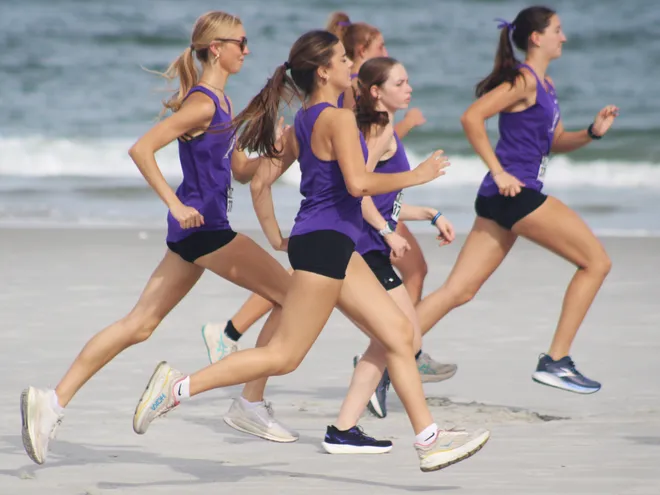 Fletcher runners warm up before the Nor'Eastern Classic high school cross country meet on Sept. 29, 2026 in Jacksonville Beach, Florida. [Clayton Freeman/Florida Times-Union]