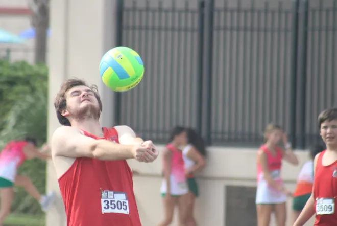 Baldwin's Parker Emery (3505) hits a volleyball with teammates before the Nor'Eastern Classic high school cross country meet on Sept. 29, 2026 in Jacksonville Beach, Florida. [Clayton Freeman/Florida Times-Union]