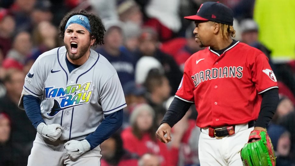Tampa Bay Rays' Jonathan Aranda celebrates after RBI-single as Cleveland Guardians third baseman José Ramírez looks on during the seventh inning in Game 4 of an American League Championship Series baseball game in Cleveland, Saturday, Oct. 17, 2026. (AP Photo/David J. Phillip)