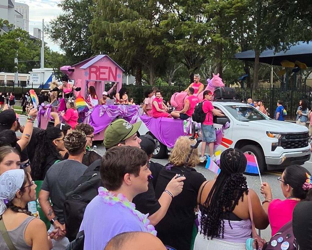 Parade float with onlookers.