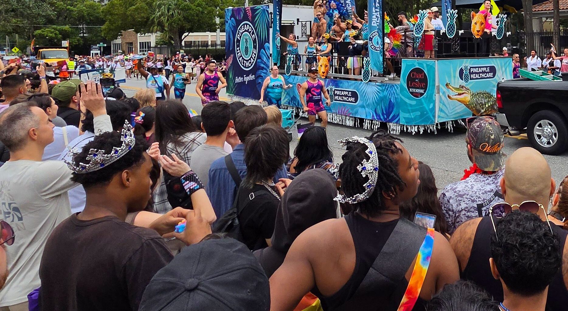 Parade float with onlookers.