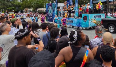 Parade float with onlookers.