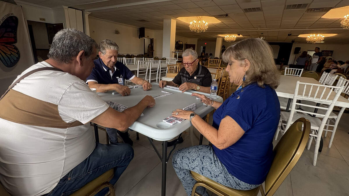 Hialeah seniors, from front, Eduardo Alfonso and Lazara Rodriguez, and in back, Raul Gonzalez and Edigio Vargas, play dominoes at Salon Tropical inside La Carreta, the new location of Little Havana Activities & Nutrition Centers after the city ended its 43-year operation at Goodlet Park.