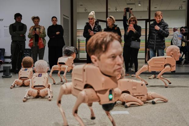 Robots in the likeness of Elon Musk, foreground, and Jeff Bezos, left, are displayed at the installation titled Regular Animals by artist Beeple, Mike Winkelmann, at the Neue Nationalgalerie museum in Berlin, Germany, Tuesday, April 28, 2026. (AP Photo/Markus Schreiber)