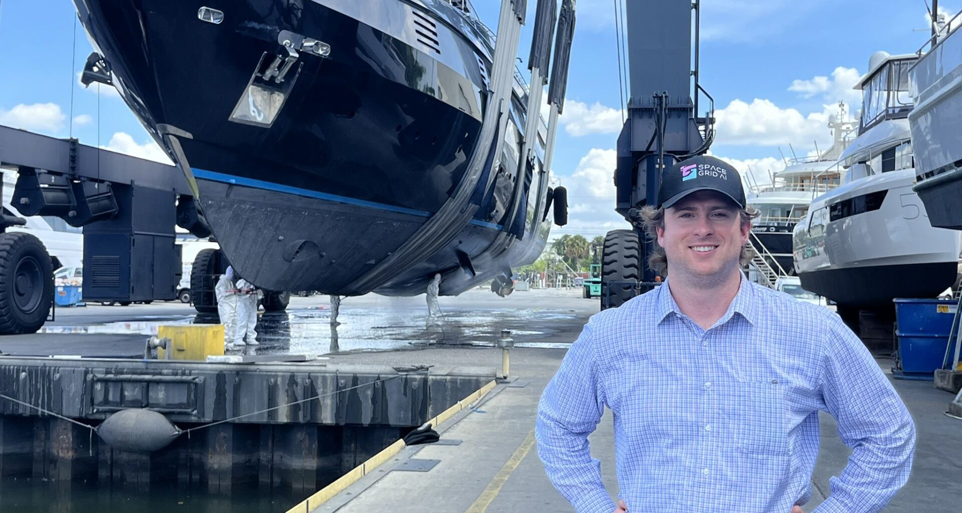 Space Grid AI founder Alex Hilger at a shipyard with a vessel being lifted
