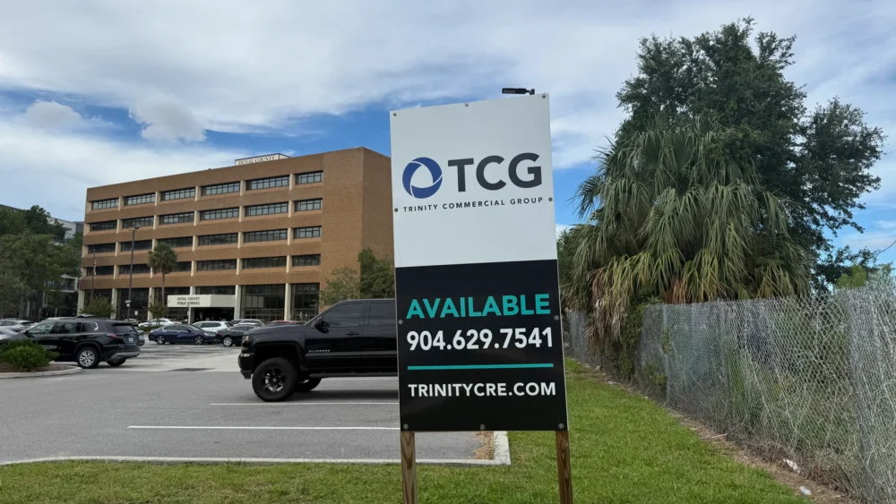 Duval Schools headquarters with a "for sale" sign in front