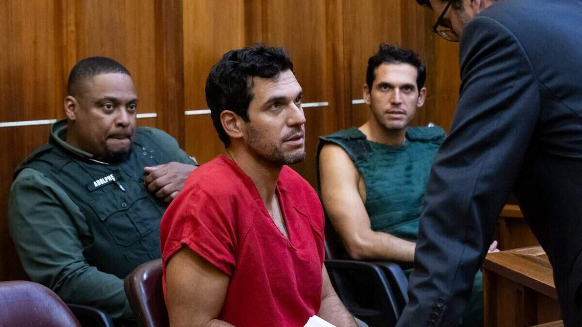 Oren Alexander, center, and his twin brother, Alon, in green jumpsuit, speak to their attorney Joel Denaro during their bond hearing at the Richard E. Gerstein Justice Building on Thursday, Dec. 12, 2024, in Miami, Fla.